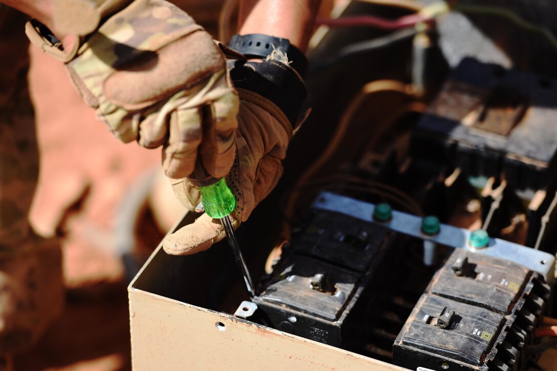 Airmen works on electrical equipment.