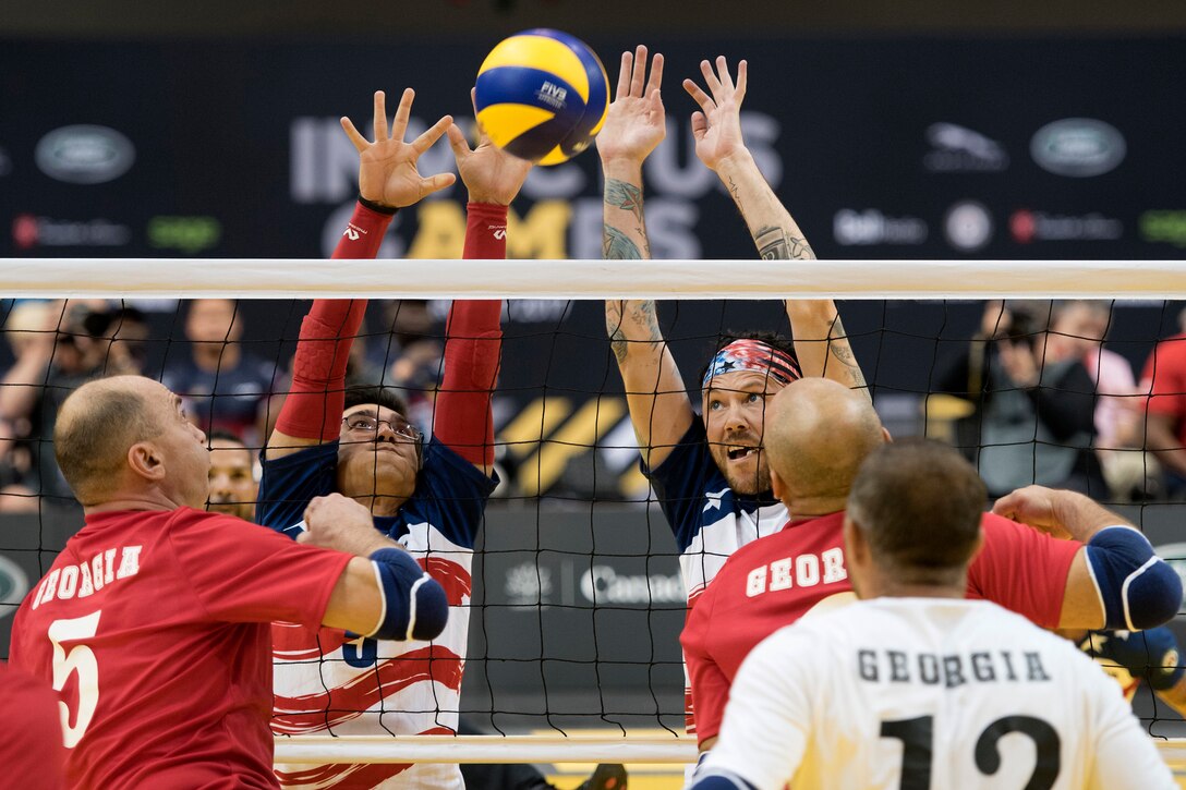 The U.S. team blocks a return by Denmark during the bronze medal match in sitting volleyball