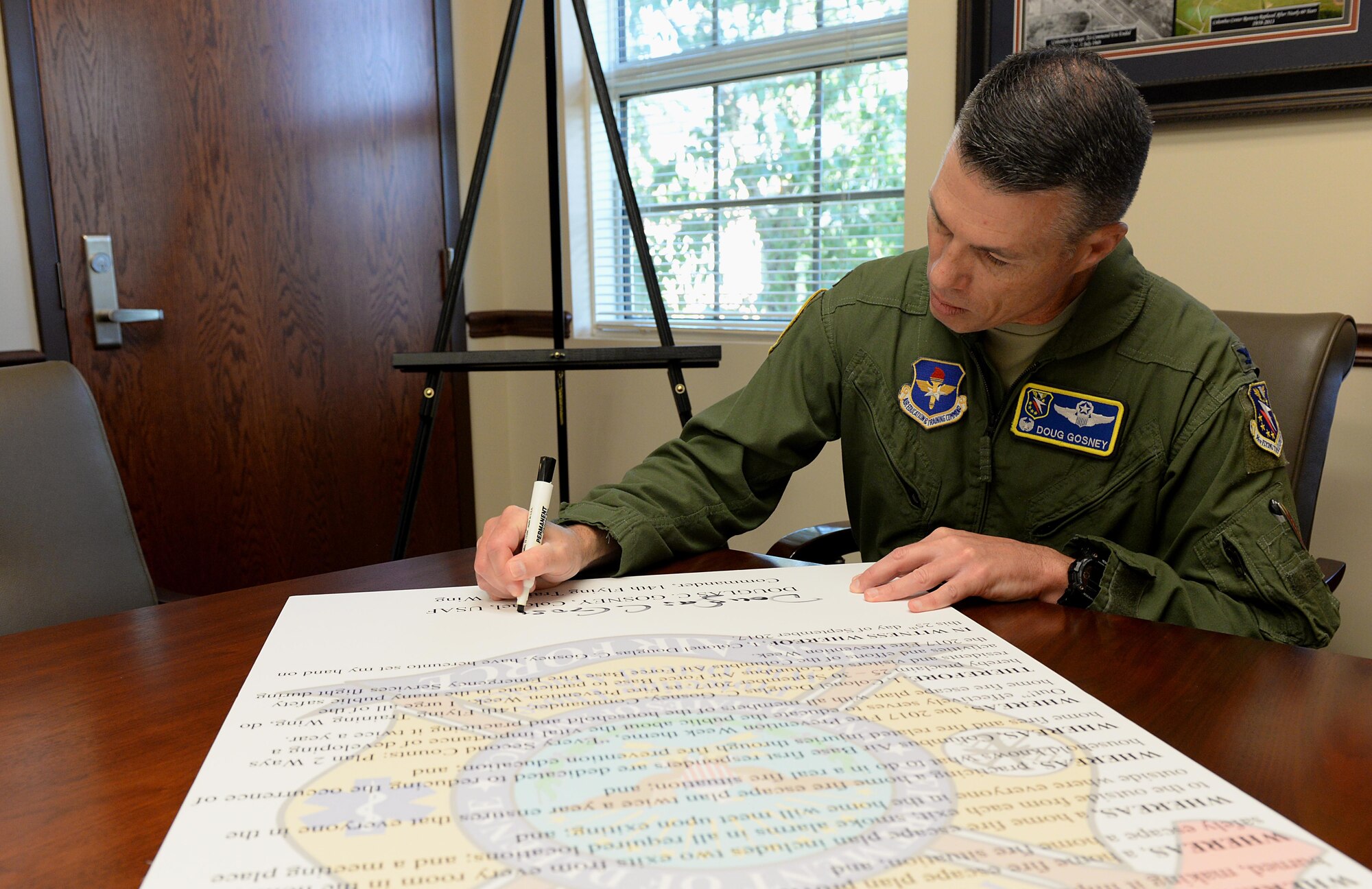 Col. Douglas Gosney, 14th Flying Training Wing Commander, signs the Fire Prevention Week Proclamation Sept. 21, 2017, on Columbus Air Force Base, Mississippi. This year’s theme is “Every Second Counts: Plan 2 Ways Out!” (U.S. Air Force photo by Airman 1st Class Keith Holcomb)