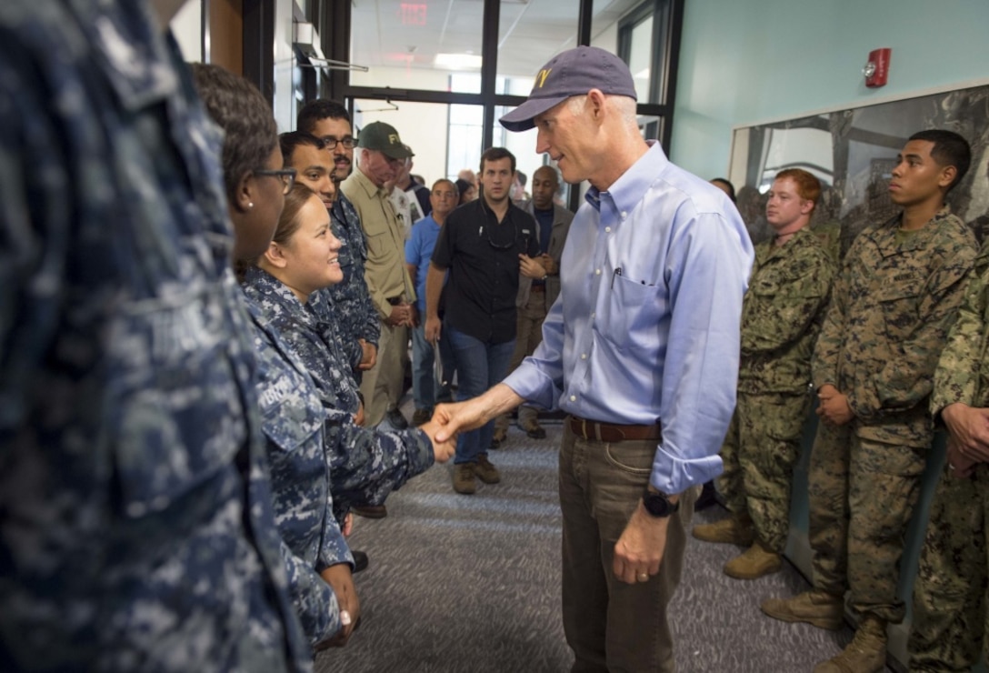 Florida governor shakes hands with sailor