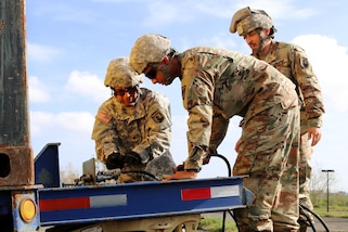 Guardsmen distribute water to residents in the San Jose community in Toa Baja, Puerto Rico, Sept. 24, 2017. Puerto Rico Army National Guard photos by Alexis Velez