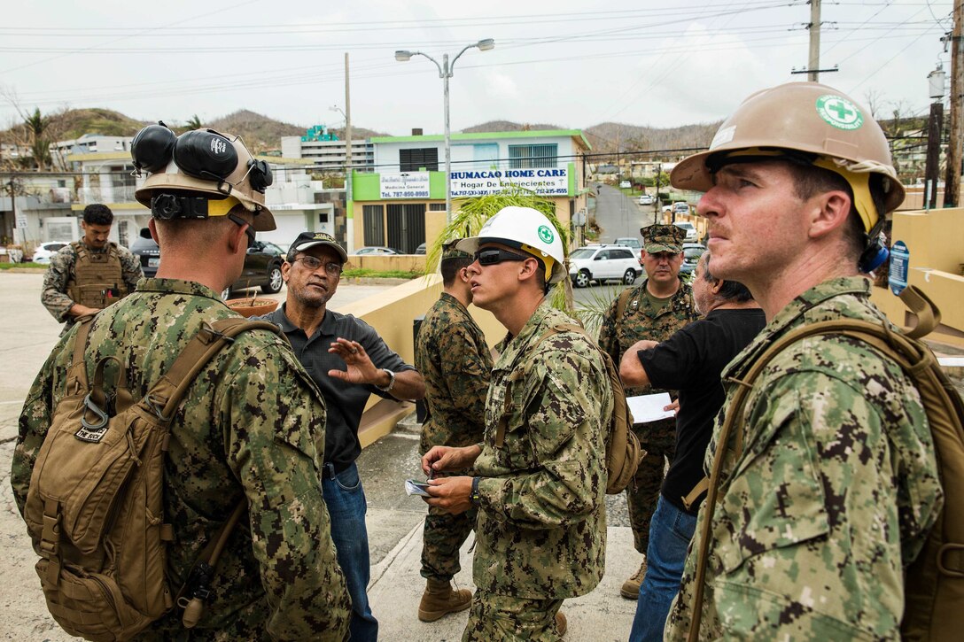 Marines and sailors speak to civilian hospital employees.