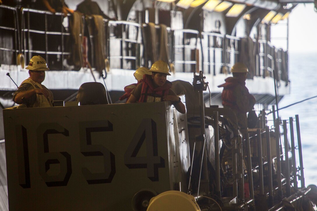 Sailors do a final check prior to departure on USS Kearsarge.