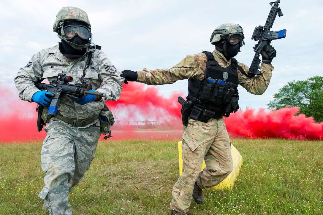 Reserve airmen rush to their next firing objective under the cover of smoke while participating in training to shoot, move and communicate.