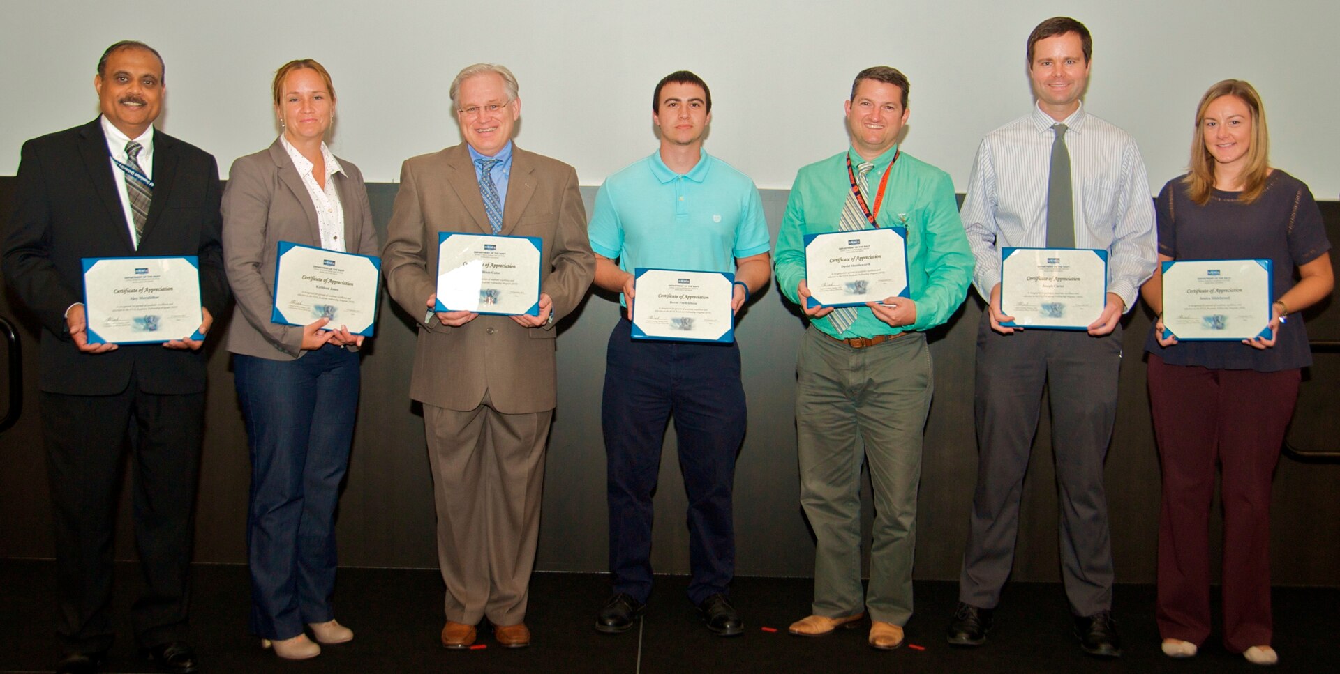 IMAGE: DAHLGREN, Va. - Ajoy Muralidhar, Kathleen Jones, William Catoe, David Fredrickson, David Shuttleworth, Joseph Carter, and Jessica Hildebrand, (l to r), are pictured with their certificates of achievement at the 2017 Naval Surface Warfare Center Dahlgren Division (NSWCDD) academic awards ceremony. The government civilians were among 13 employees selected for the fiscal year 2018 Academic Fellowship Program. The competitive program accelerates academic and professional growth of employees and contributes to the increase in degrees awarded at Dahlgren. This year, nine of the selected employees are progressing in their master’s degree programs in fields of study that include cyber security engineering, business administration, systems engineering, engineering management, and computer science. One selected employee is working on a bachelor's degree in physics through the program. The command’s academic fellowship program is also helping three engineers complete doctoral degree programs - one in electrical engineering, another in engineering management and systems engineering, and the third in modeling and simulation.