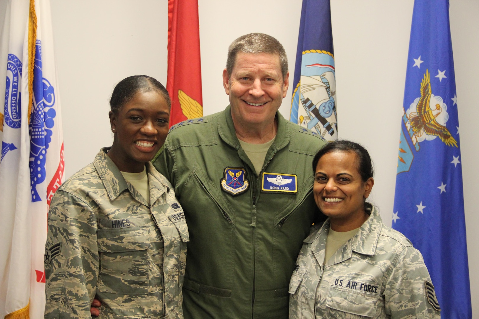 Gen. Rand poses for a photo with two NSWC Crane employees, SrA Cherelle Hines (left) and TSgt Anjuli Smith (right), following his all-hands presentation.