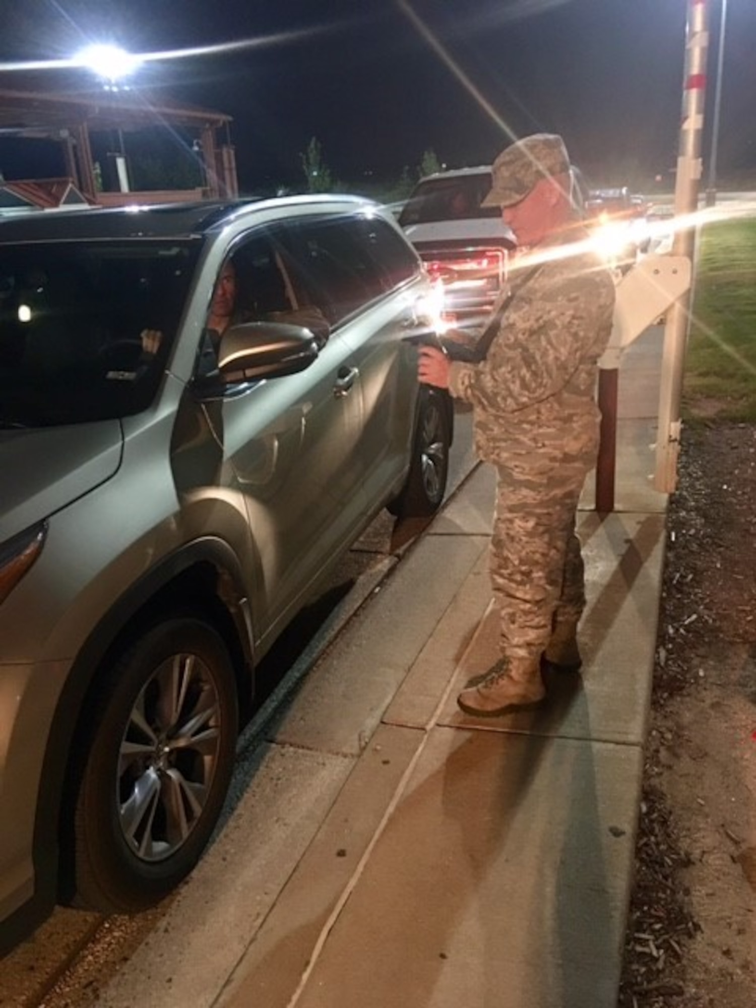 Chaplain (Capt.) John Boulware, 21st Space Wing chaplain, scans identifications and hangs out with the 21st Security Force Squadron gate guards Aug. 23, 2017 at Peterson Air Force Base, Colorado. Boulware fulfills his mission by spending time with the Airmen he serves. (Courtesy photo)