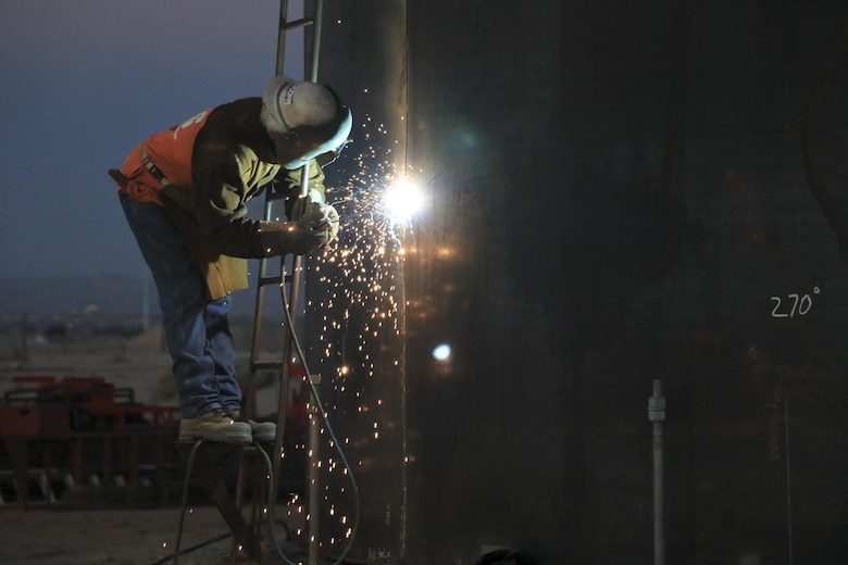 Upgrades to the refueling system at Nellis Air Force Base, Nevada, will increase the pumping capacity to 2,400 gallons per minute for 25 multi-aircraft revetments and six bomber outlets. Two new 420,000 gallon aboveground operating storage tanks will feed the system. During the hot summer months, nearly around the clock construction is overseen by the U.S. Army Corps of Engineers Los Angeles District's Las Vegas Resident Office.