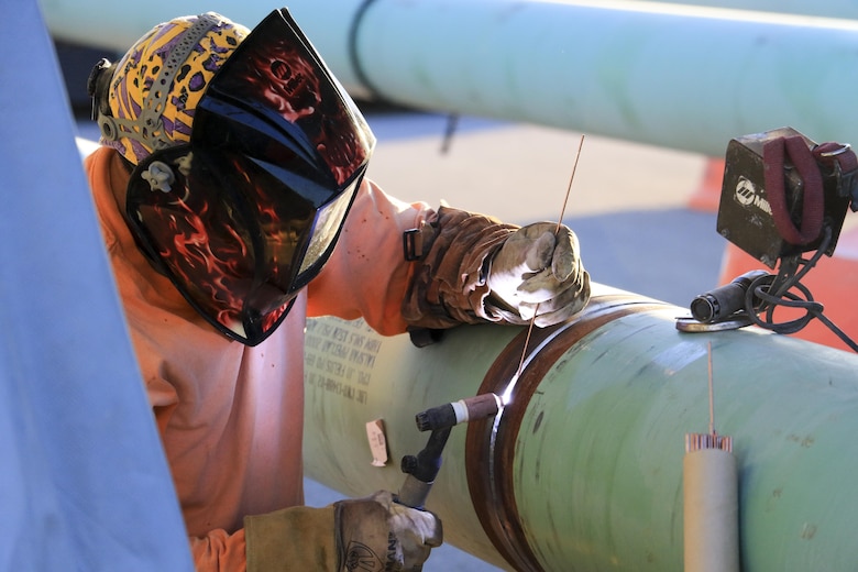 Upgrades to the refueling system at Nellis Air Force Base, Nevada, will increase the pumping capacity to 2,400 gallons per minute for 25 multi-aircraft revetments and six bomber outlets. Two new 420,000 gallon aboveground operating storage tanks will feed the system. During the hot summer months, nearly around the clock construction is overseen by the U.S. Army Corps of Engineers Los Angeles District's Las Vegas Resident Office.