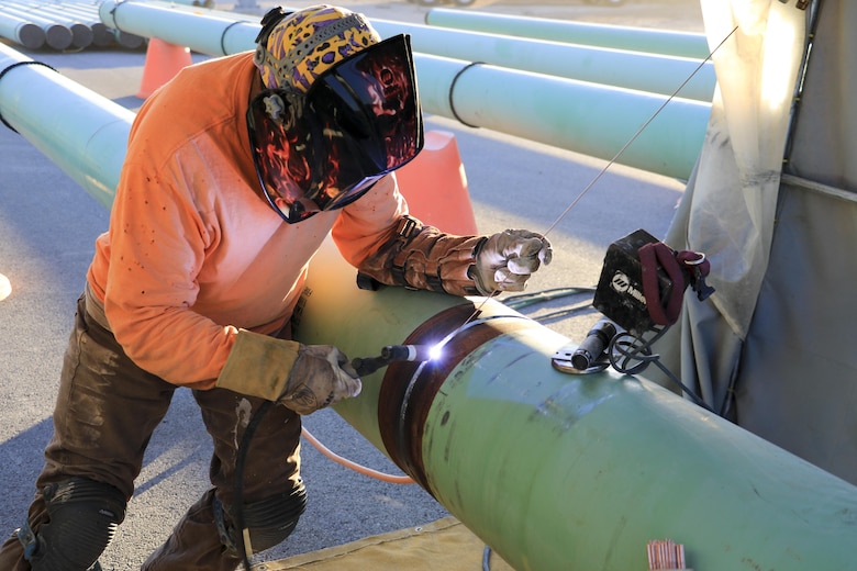 Upgrades to the refueling system at Nellis Air Force Base, Nevada, will increase the pumping capacity to 2,400 gallons per minute for 25 multi-aircraft revetments and six bomber outlets. Two new 420,000 gallon aboveground operating storage tanks will feed the system. During the hot summer months, nearly around the clock construction is overseen by the U.S. Army Corps of Engineers Los Angeles District's Las Vegas Resident Office.