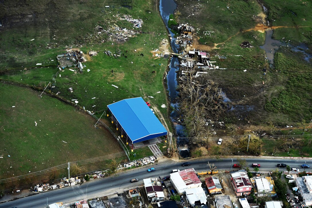 Debris and damage buildings are seen from above.
