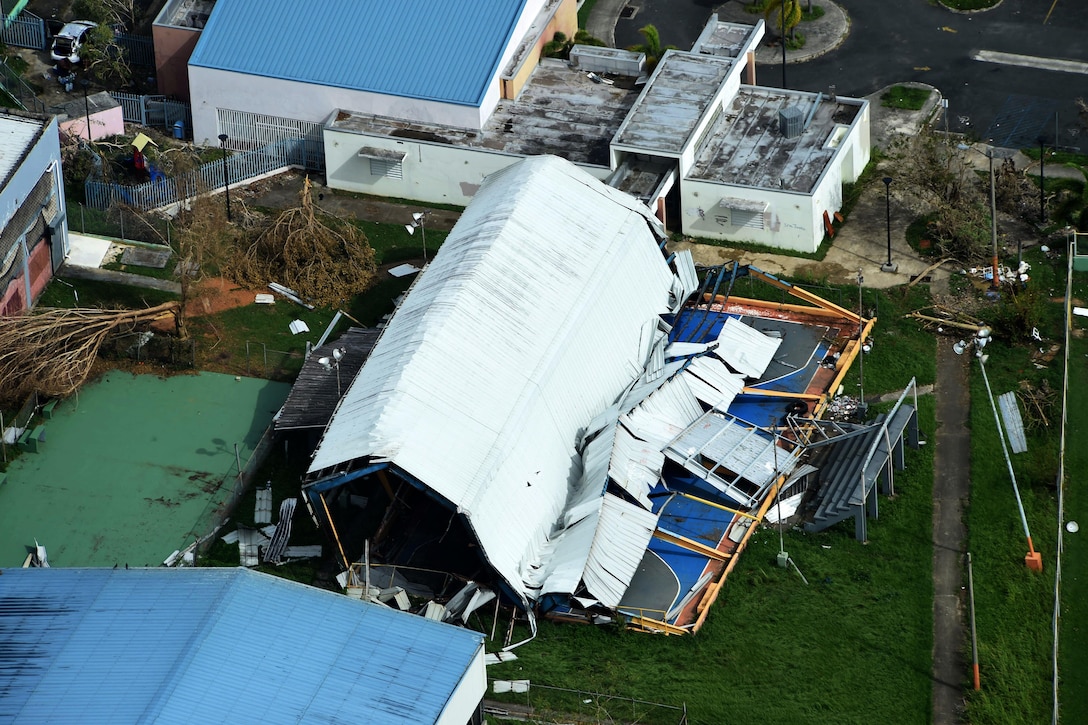 A heavily damaged building is seen from above.