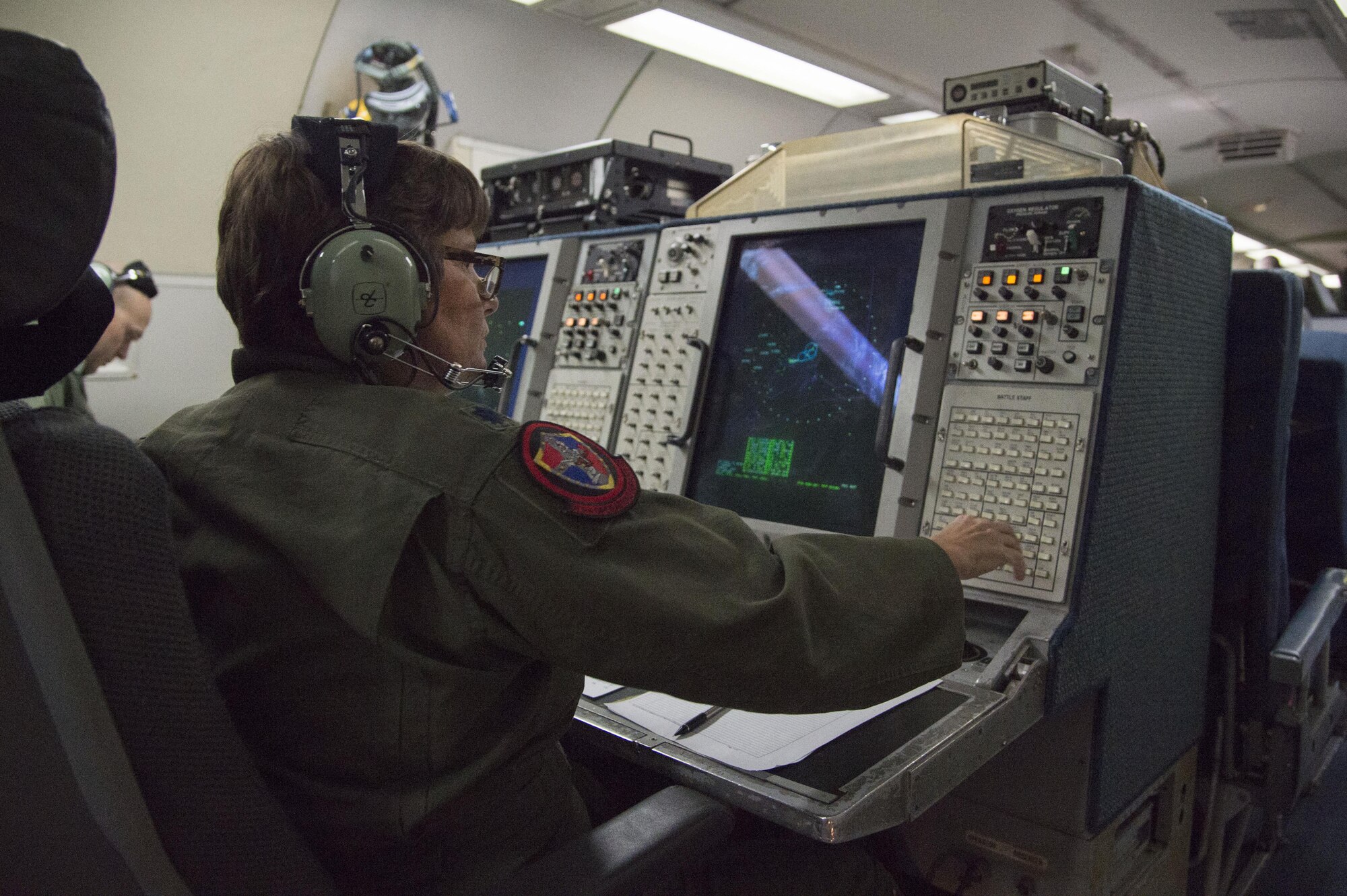 Air Force Lt. Col. Elaine Boyd, 970th Airborne Air Control Squadron mission crew commander, monitors air activity on board an E-3 Sentry Airborne Warning and Control aircraft during a surveillance training mission, Sept. 20, 2017. Reservists from the 970th AACS based at Tinker Air Force Base, Okla., visited Joint Base Elmendorf-Richardson for a nine-day total force mission where they fully integrated with the active-duty 962nd AACS.
