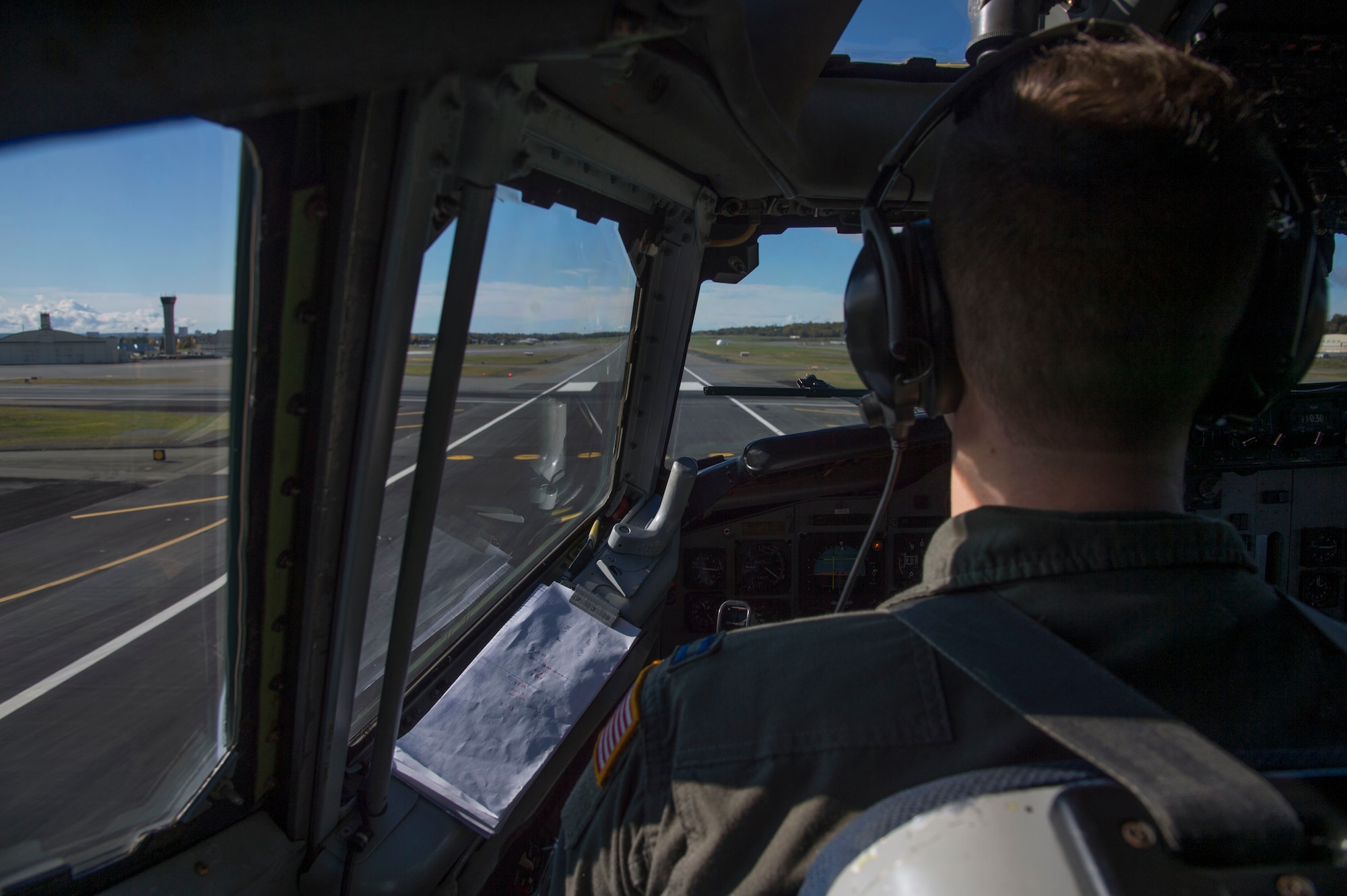Air Force Capt. Joshua Johnson, 962nd Airborne Air Control Squadron instructor pilot, assists with the landing of an E-3 Sentry Airborne Warning and Control aircraft at Joint Base Elmendorf-Richardson, Alaska, Sept. 20, 2017. Reservists from the 970th AACS based at Tinker Air Force Base, Okla., visited Joint Base Elmendorf-Richardson for a nine-day total force mission where they fully integrated with the active-duty 962nd AACS.