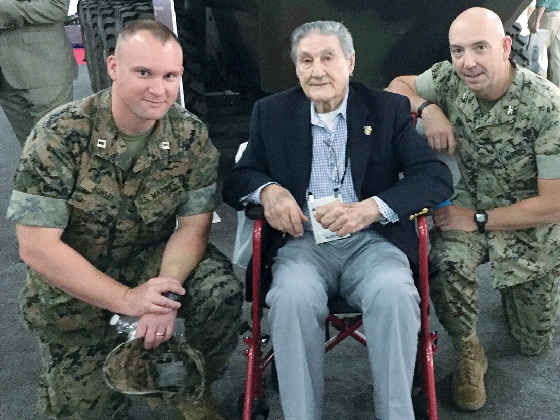 Capt. Mike Howley, Program Executive Officer (PEO) Land Systems (LS) command, WWII veteran Marine Tech Sgt. Theodore R. Marolda Sr. and Col. Kirk Mullins, ACV product manager, PEO LS toured the Modern Day Marine Military Exposition Sept. 20 to show Marolda how equipment has changed since he served in the Corps.