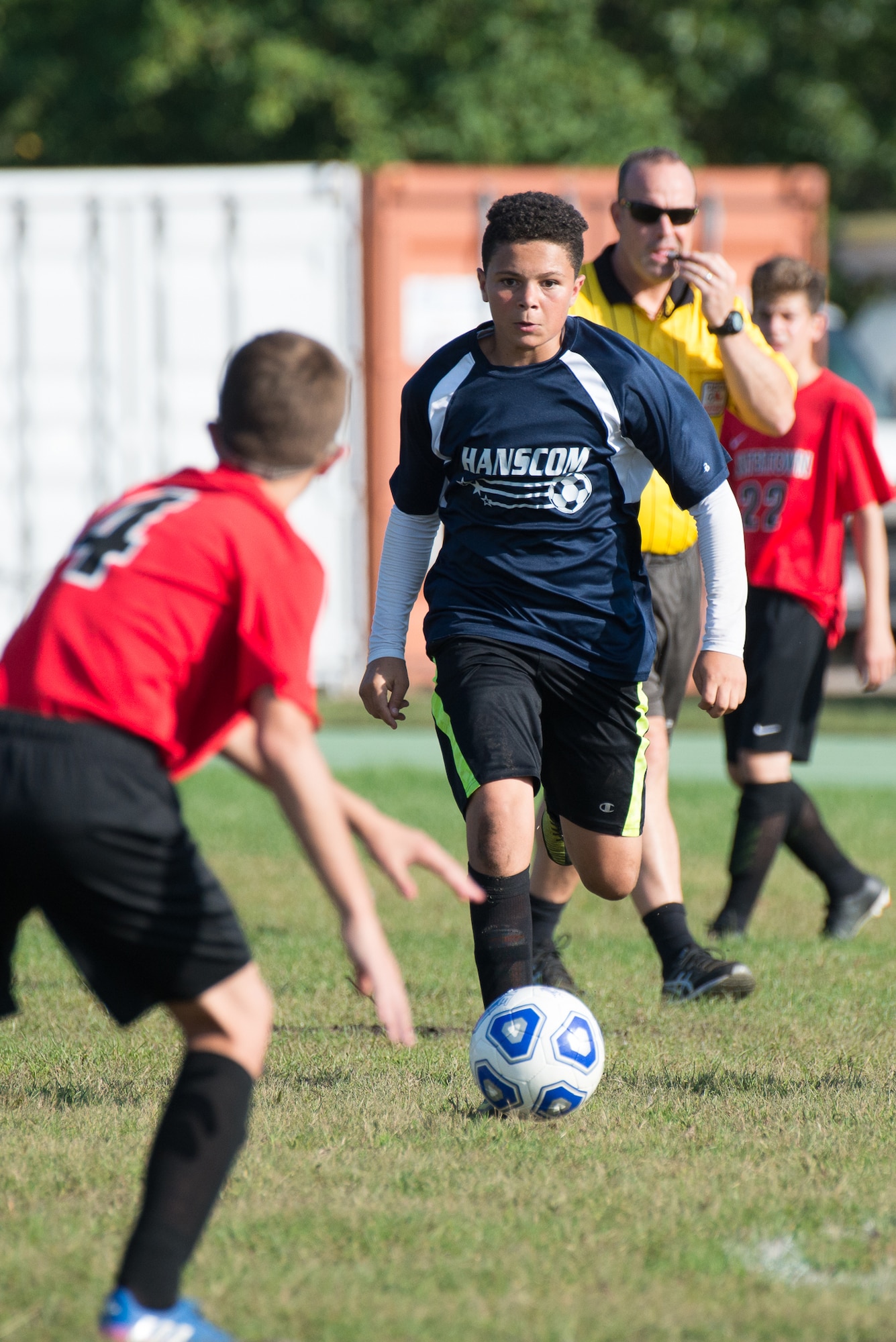 Evan Squire, a member of the Hanscom Middle School boys soccer team, runs with the ball during a home match against Watertown Middle School.