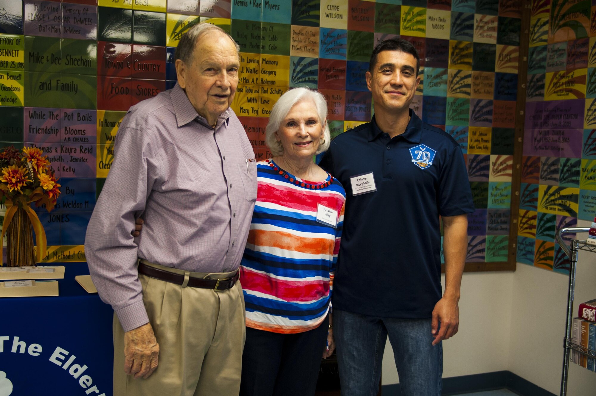 Morgan Riley, volunteer, Barbara Riley, vocational services director, and U.S. Air Force Col. Ricky Mills, 17th Training Wing commander, pose for a photo at the Meals for the Elderly center San Angelo, Texas, Sept. 27, 2017. From the organization’s website, Meals for the Elderly is a private, non-profit charitable organization devoted to serving the homebound elderly of San Angelo, Texas and surrounding areas with one hot, nutritious, home-delivered meal each weekday, while also ensuring their individual well-being through personal contact. (U.S. Air Force photo by Senior Airman Scott Jackson/Released