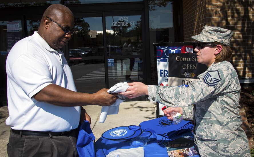 Master Sgt. Terri Adams, 23d Civil Engineer Squadron section chief of emergency management, hands a cooling towel to retired Master Sgt. Roger Cooper during the National Preparedness event, Sept. 27, 2017 at Moody Air Force Base, Ga.  Members from the 23d CES partnered with the American Red Cross to raise awareness and give out information on preparing for natural disasters. (U.S. Air Force photo by Airman Eugene Oliver)