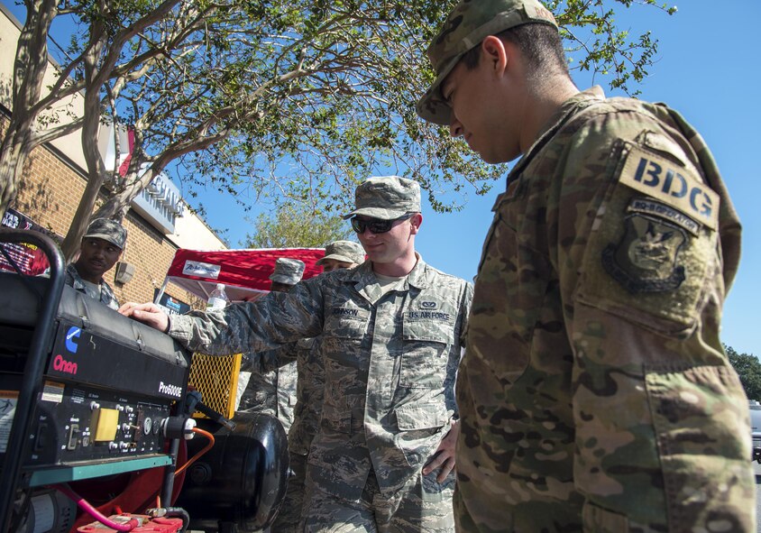 Senior Airman Alex Johnson, 23d Civil Engineer Squadron electric power production specialist, speaks to Airman First Class Alejandro Rodriguez, 823d Base Defense Squadron fire team member, during the National Preparedness event, Sept. 27, 2017 at Moody Air Force Base, Ga. Johnson gave lessons on the do’s and don’ts of how to properly use a generator to power one’s home in the case of a natural disaster. (U.S. Air Force photo by Airman Eugene Oliver)