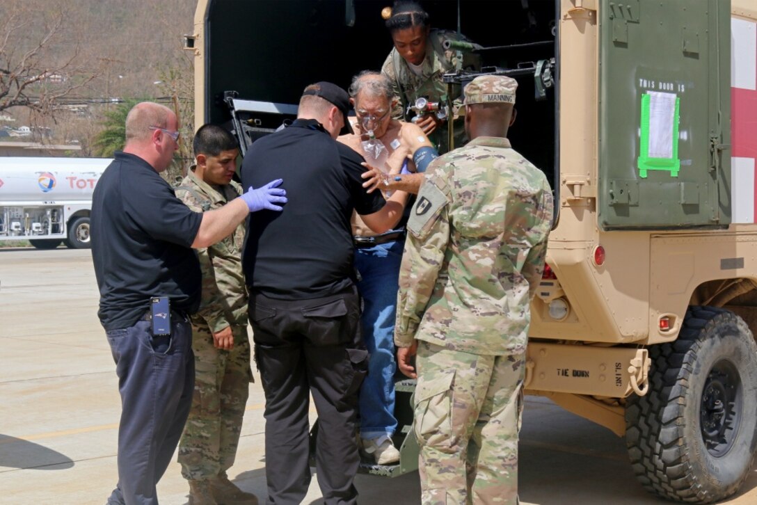 Flight medics from MedCenter Air, and Army medics assigned to the 602nd Area Support Medical Company, 261st Multifunctional Medical Battalion, 44th Medical Brigade, Fort Bragg, N.C., help a patient