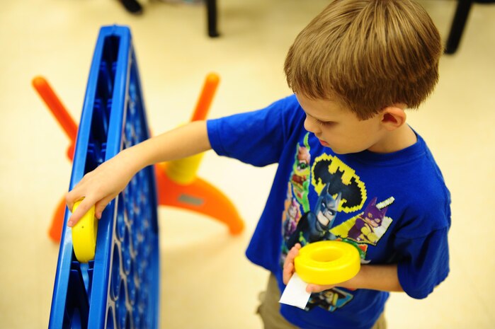 Lucas Jessen Plays a large sized connect four during Day for Kids at the Joint Base Charleston Weapons Station Youth Center Sept. 21, 2017.
