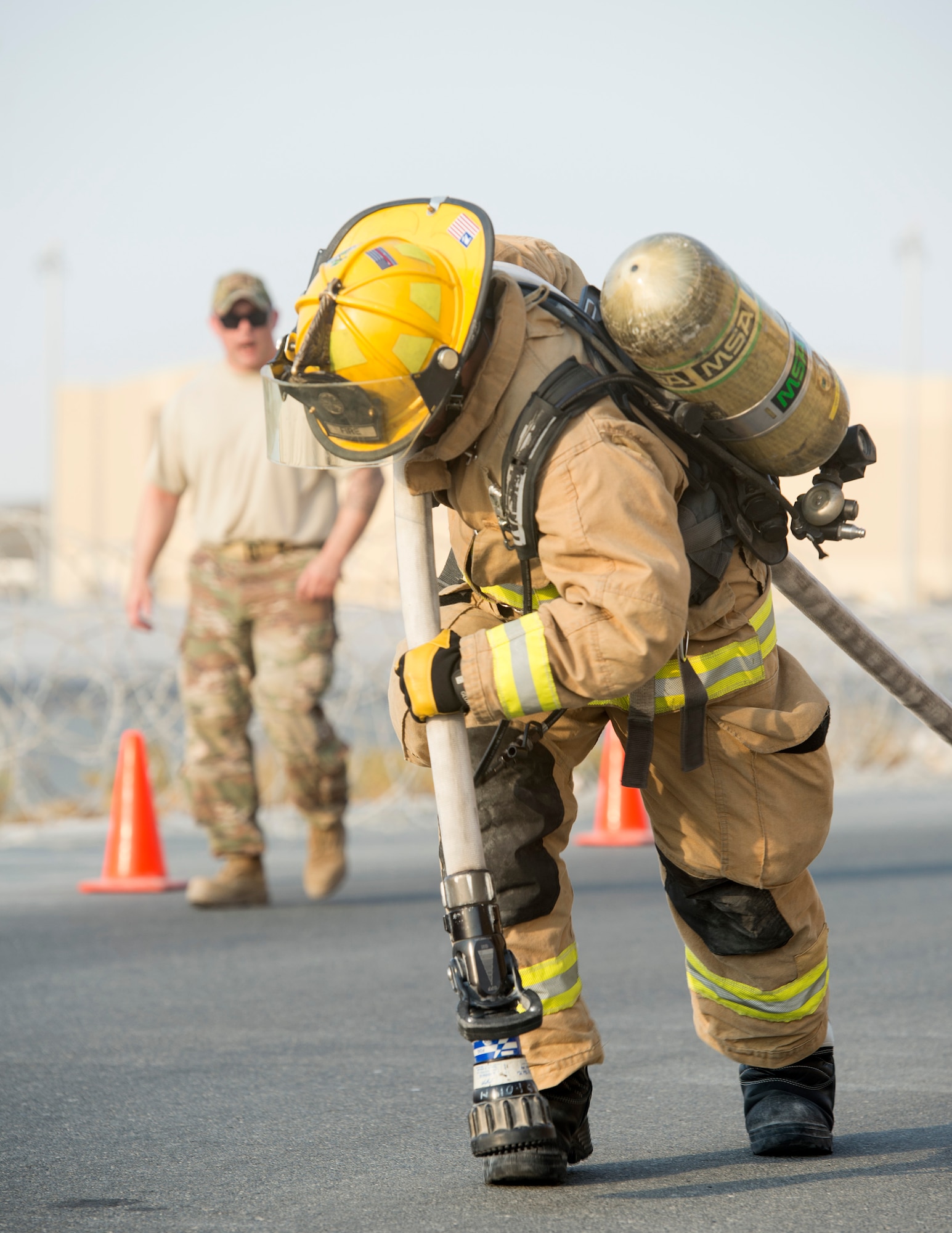 U.S. Air Force Senior Airman John Hodgkins, firefighter with the 379th Expeditionary Civil Engineer Squadron’s Fire and Emergency Services Flight, drags a hose 150 feet to the end of station two during a firefighter combat challenge at Al Udeid Air Base, Qatar, Sept. 1, 2017.