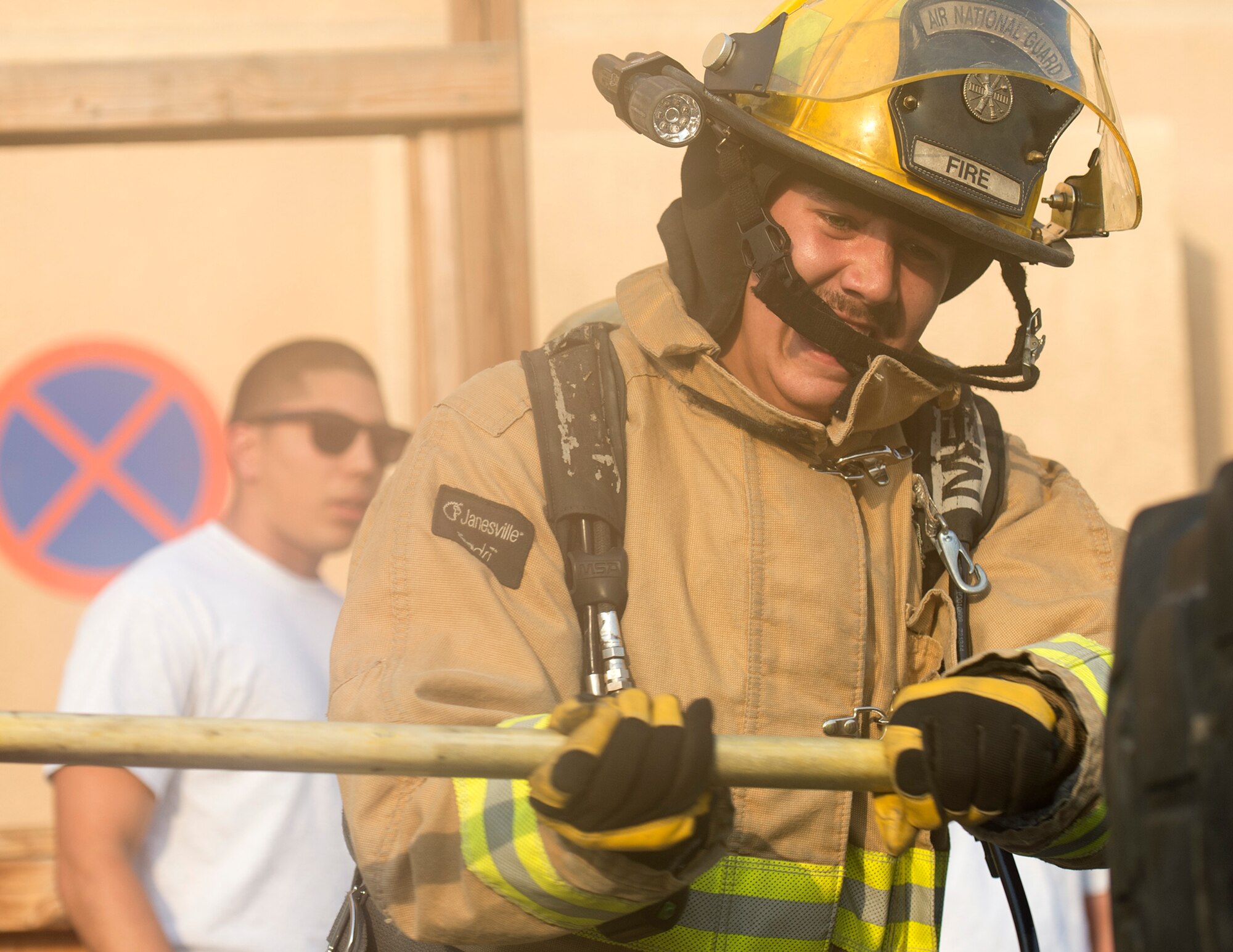 U.S. Air Force Senior Airman John Hodgkins, firefighter with the 379th Expeditionary Civil Engineer Squadron’s Fire and Emergency Services Flight, fits a tire with a slug hammer during a firefighter combat challenge at Al Udeid Air Base, Qatar, Sept. 1, 2017.