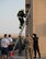 A firefighter with the Qatar Emiri Air Force Fire Department, Doha Air Base, climbs a ladder during a firefighter combat challenge at Al Udeid Air Base, Qatar, Sept. 1, 2017.