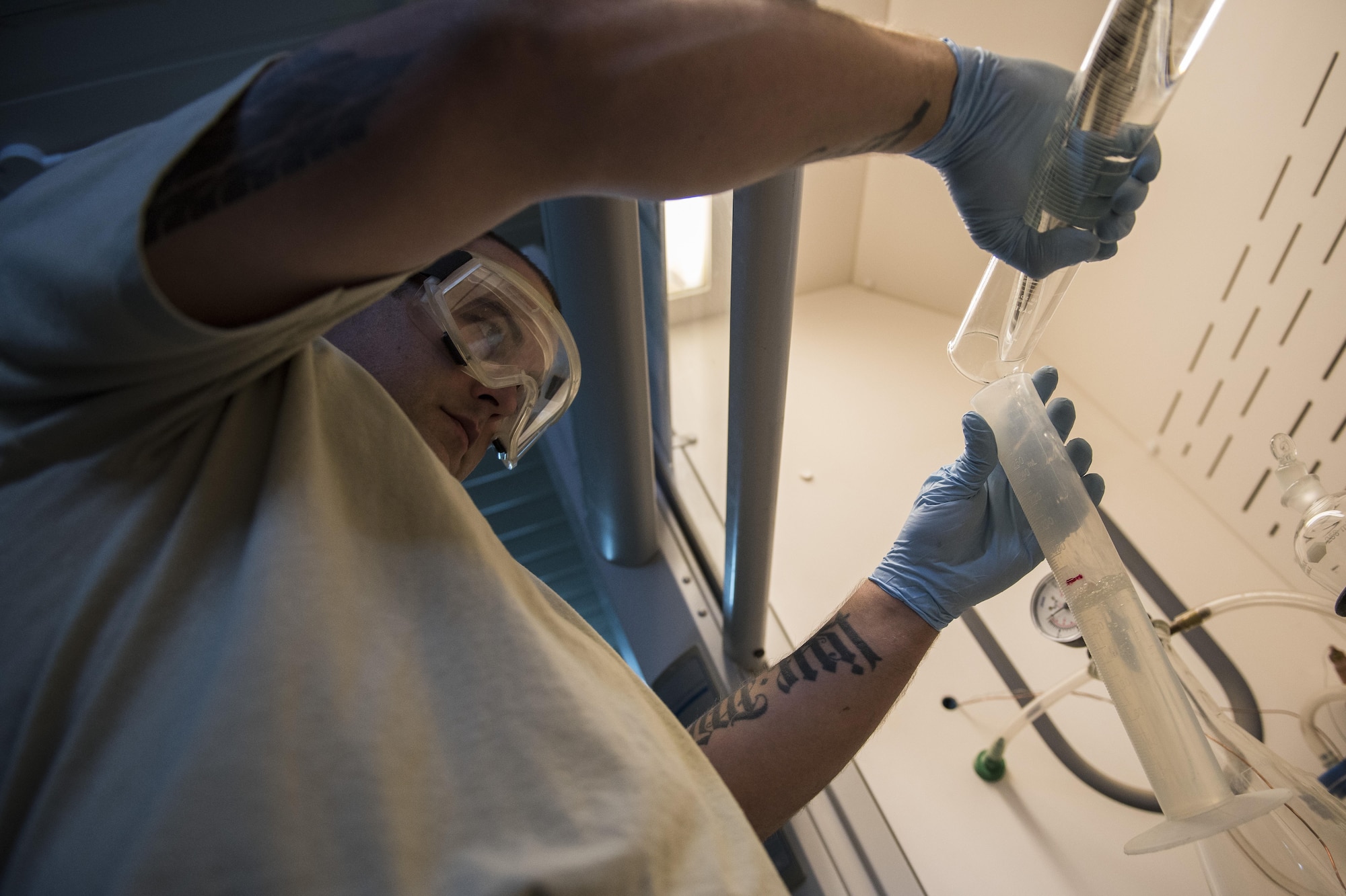 Tech. Sgt. Alex Johnson, 332nd Expeditionary Logistics Readiness Squadron fuels flight lab technician, transfers fuel between cylinders to perform different tests. The samples are tested to ensure the fuel is clean prior to it being completely offloaded. (U.S. Air Force photo/Senior Airman Damon Kasberg)