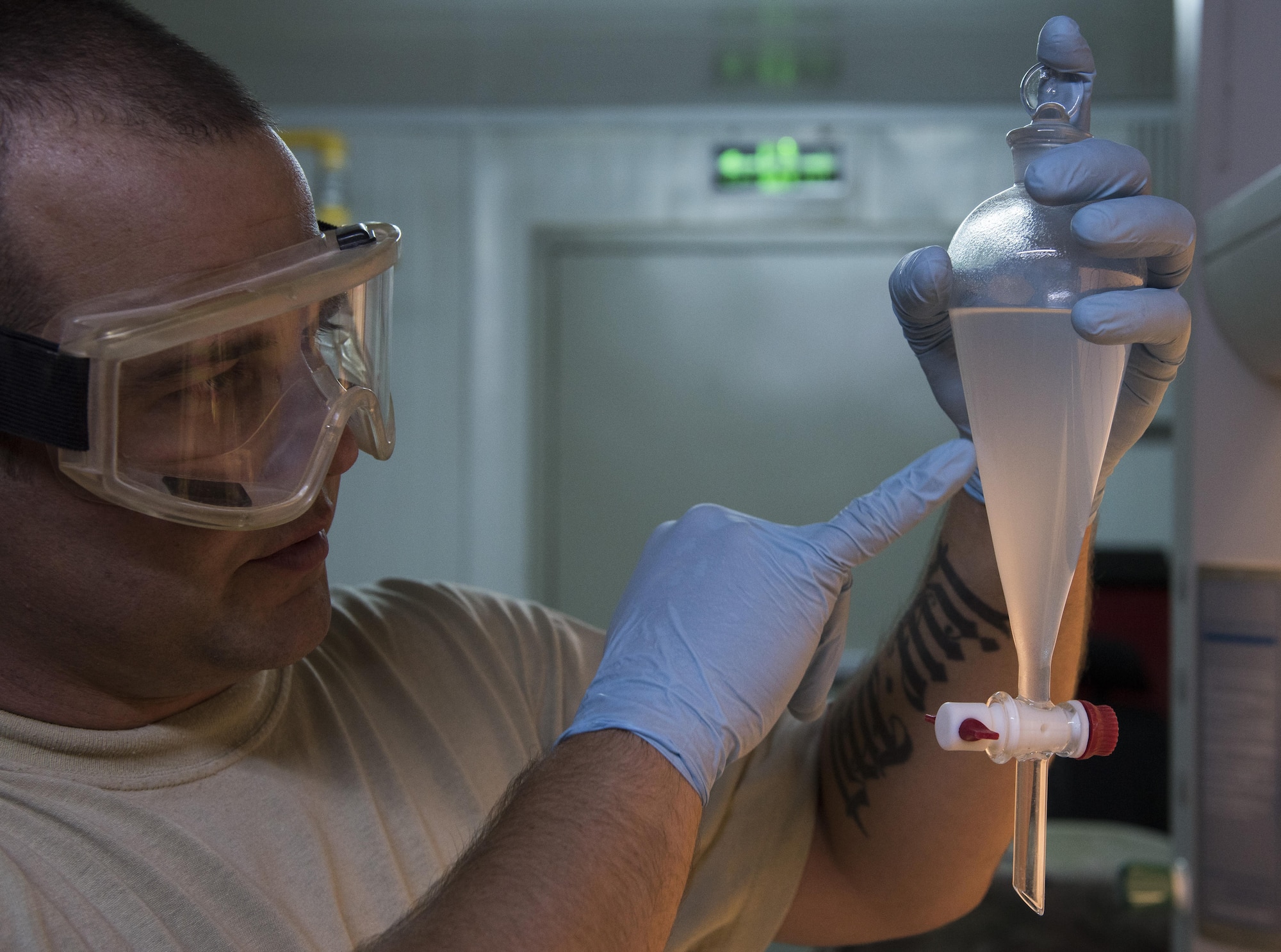 Tech. Sgt. Alex Johnson, 332nd Expeditionary Logistics Readiness Squadron fuels flight lab technician, checks for fuel system icing inhibitor on a recent fuel delivery July 22, 2017 in Southwest Asia.  The samples are tested to ensure the fuel is clean prior to it being completely offloaded. (U.S. Air Force photo/Senior Airman Damon Kasberg)