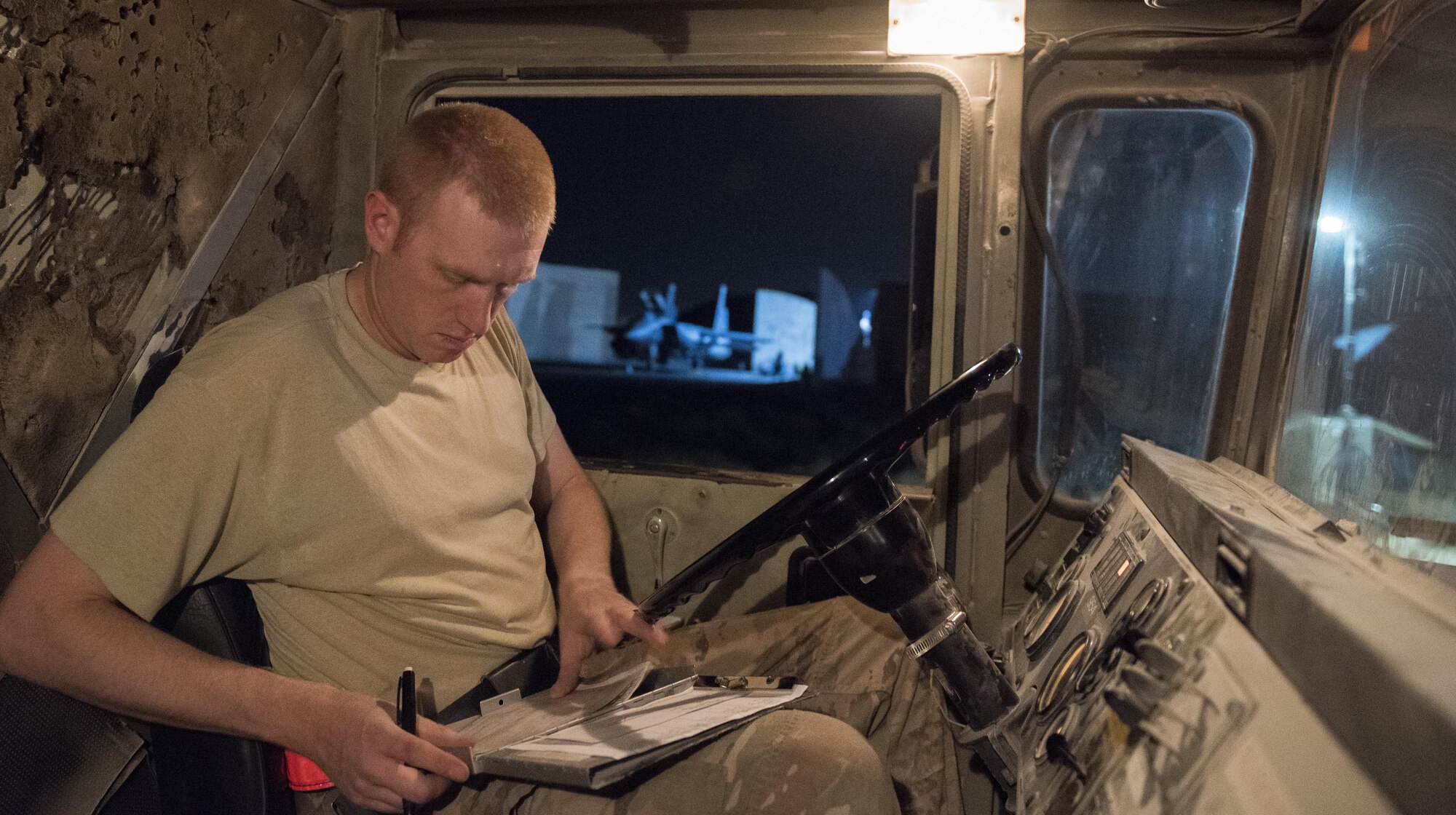 Staff Sgt. Kenneth Zaun, 332nd Expeditionary Logistics Readiness Squadron fuels flight controller, fills out paperwork prior to fueling an F-15E Strike Eagle, July 22, 2017 in Southwest Asia. Within 20 minutes of landing, members of the 332nd ELRS are in place to refuel aircraft for its next mission. (U.S. Air Force photo/Senior Airman Damon Kasberg)
