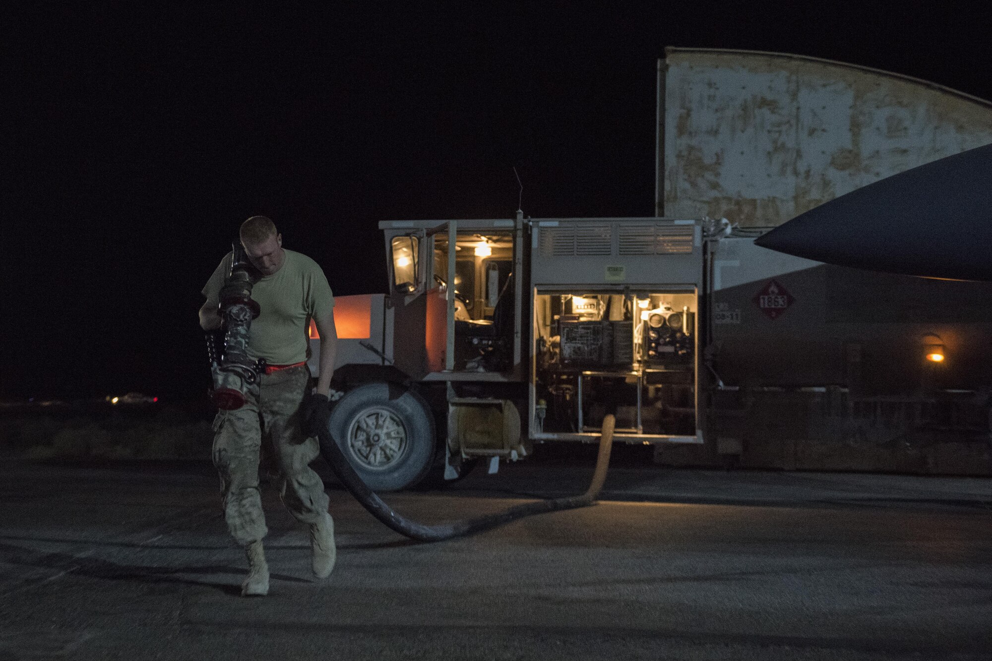 Staff Sgt. Kenneth Zaun, 332nd Expeditionary Logistics Readiness Squadron fuels flight controller, pulls out a fuel nozzle to refuel a F-15E Strike Eagle, July 22, 2017 in Southwest Asia. Within 20 minutes of landing members of the 332nd ELRS are in place to refuel aircraft for its next mission. (U.S. Air Force photo/Senior Airman Damon Kasberg)