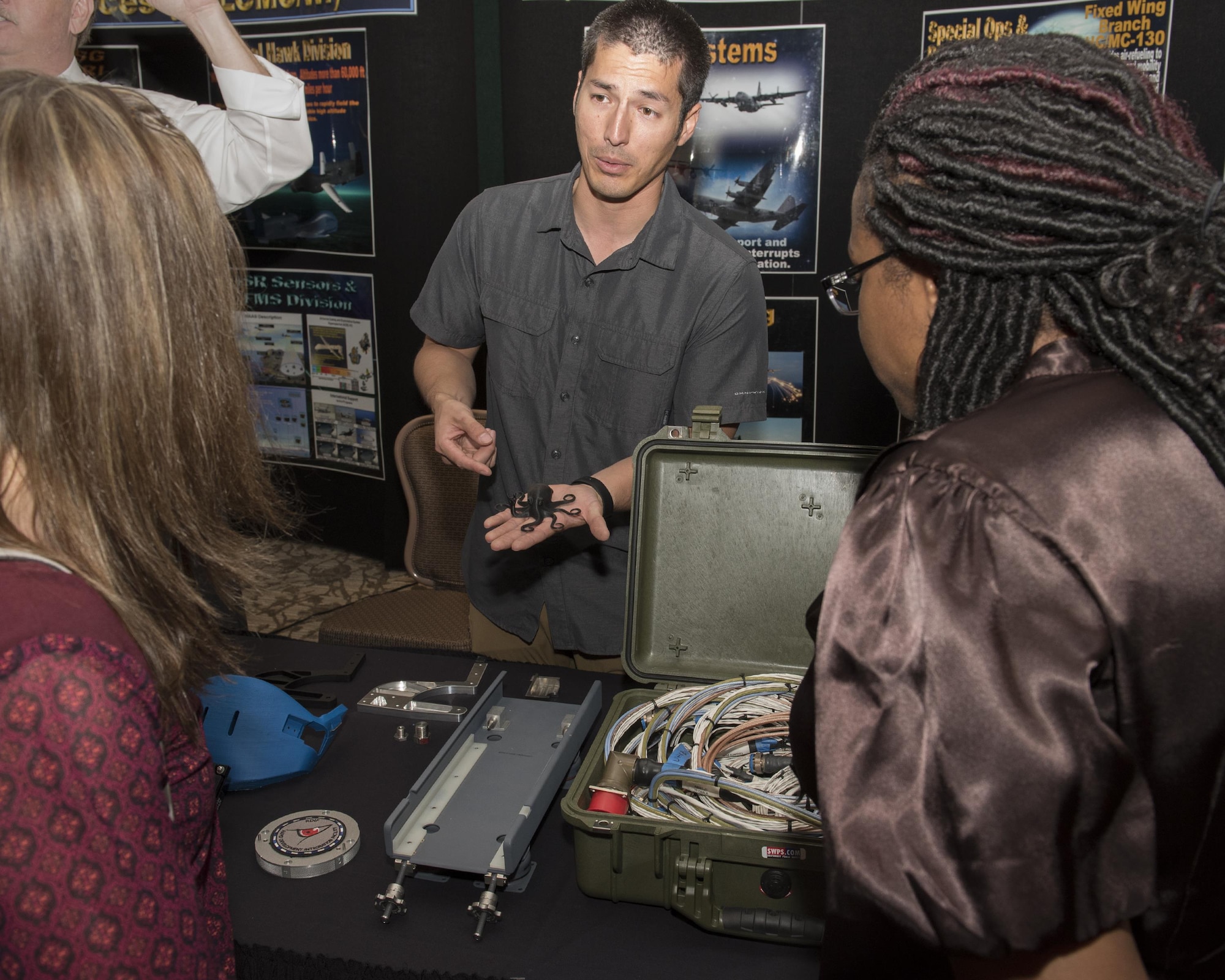 Chris Buck, (center) Rapid Development Integration Facility program manager,
show a test article example to visitors during the Air Force Life Cycle
Management Center's Newcomers Expo at Wright-Patterson Air Force Base Sept.
22. RDIF build and deliver weapon system modifications for items that do not
currently exist on a weapon system, are too expensive or are no longer
produced. (U.S. Air Force photo/Michelle Gigante)