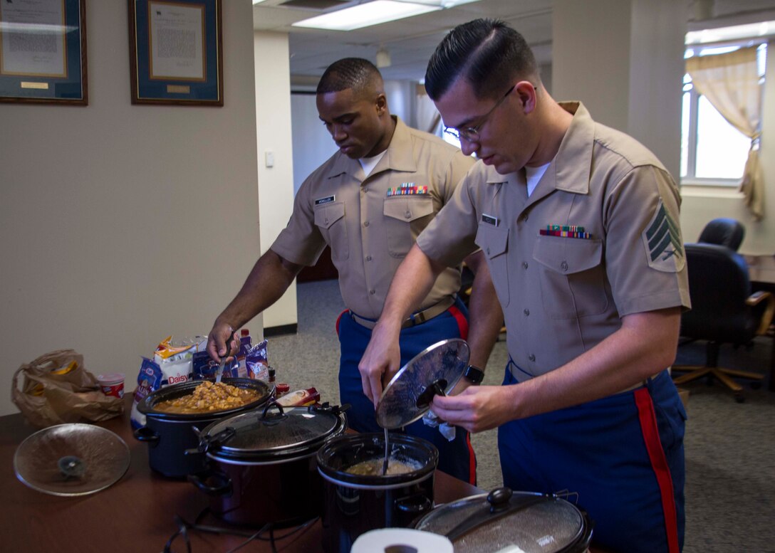 Sergeant Matthew W. Rodas, personnel chief with 6th Marine Corps District (6MCD), right, and Staff Sgt. Wi McMullen, comptroller chief with 6MCD, left, set up the chili cook-off during Mission Day at the 6MCD Headquarters aboard Marine Corps Recruit Depot Parris Island, South Carolina, Sept. 27, 2017. Mission Day commemorates the hard work and dedication of the Marines, Sailors, and civilians of 6MCD. (U.S. Marine Corps photo by Lance Cpl. Jack A. E. Rigsby)