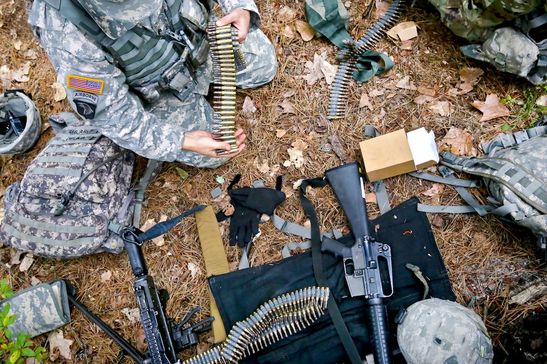 Army National Guardsmen ready their tactical gear while on a field training exercise.