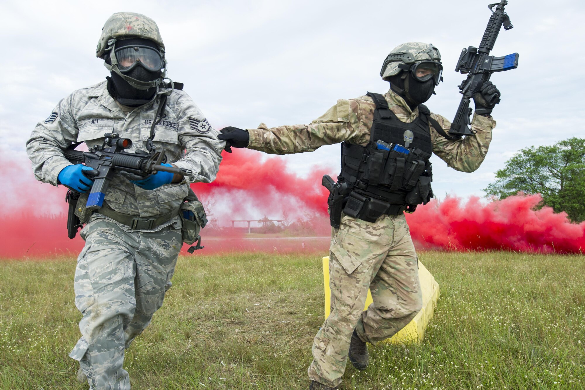 Reserve Citizen Airmen from the 482nd Security Force Squadron, Homestead Air Reserve Base, Florida, take cover and return fire while participating in a shoot, move, and communicate training with sim-munitions on September 26, 2017.  This annual training for security forces members helps keep the airmen proficient in many situation they may encounter stateside or overseas. (U.S. Air Force photo by Staff Sgt. Kyle Brasier)