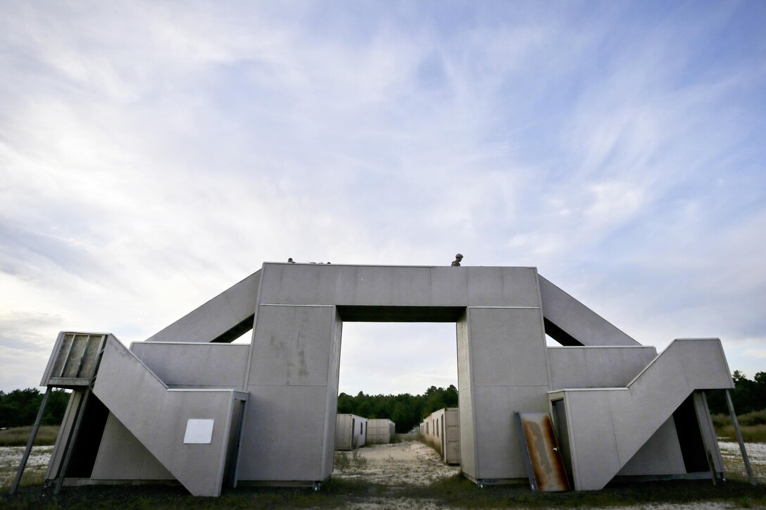 Guardsmen provide security from an overpass while on a field training exercise.