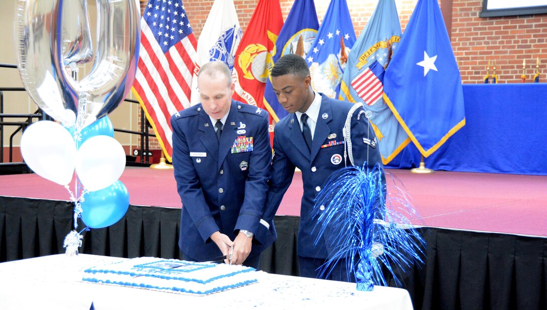 The cake is cut by the oldest and youngest members of the Air Force at Defense Supply Center Richmond, Virginia.