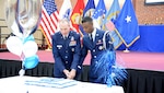 The cake is cut by the oldest and youngest members of the Air Force at Defense Supply Center Richmond, Virginia.