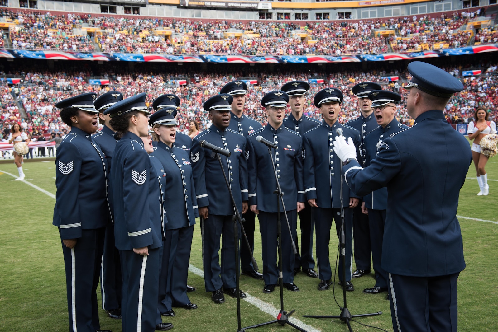 Members of the Singing Sergeants, conducted by Capt. Dustin Doyle perform the National Anthem prior to a Washington Redskins game at FedEx Field in 2017 (U.S. Air Force Photo by CMSgt Bob Kamholz/Released)