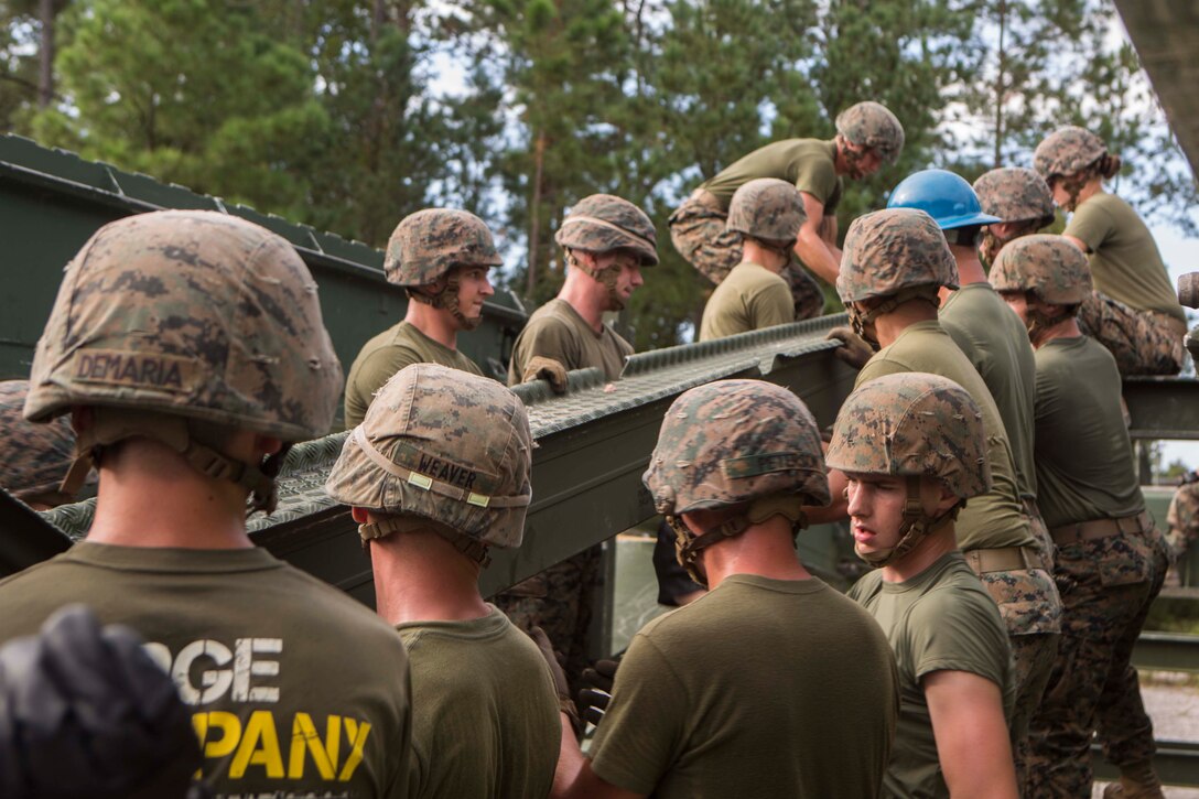 Marines with Bridge Company, 8th Engineer Support Battalion, assemble a 16-bay, double story medium girder bridge during a bridge commanders course at Camp Lejeune, N.C., Sept. 27, 2017. The course was designed to improve the ability of the bridge commander to coordinate the construction of a bridge in a timely manner. (U.S. Marine Corps photo by Lance Cpl. Abrey D. Liggins)