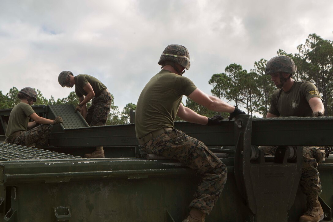 Marines with Bridge Company, 8th Engineer Support Battalion, assemble a 16-bay, double story medium girder bridge during a bridge commanders course at Camp Lejeune, N.C., Sept. 27, 2017. The course was designed to improve the ability of the bridge commander to coordinate the construction of a bridge in a timely manner. (U.S. Marine Corps photo by Lance Cpl. Abrey D. Liggins)