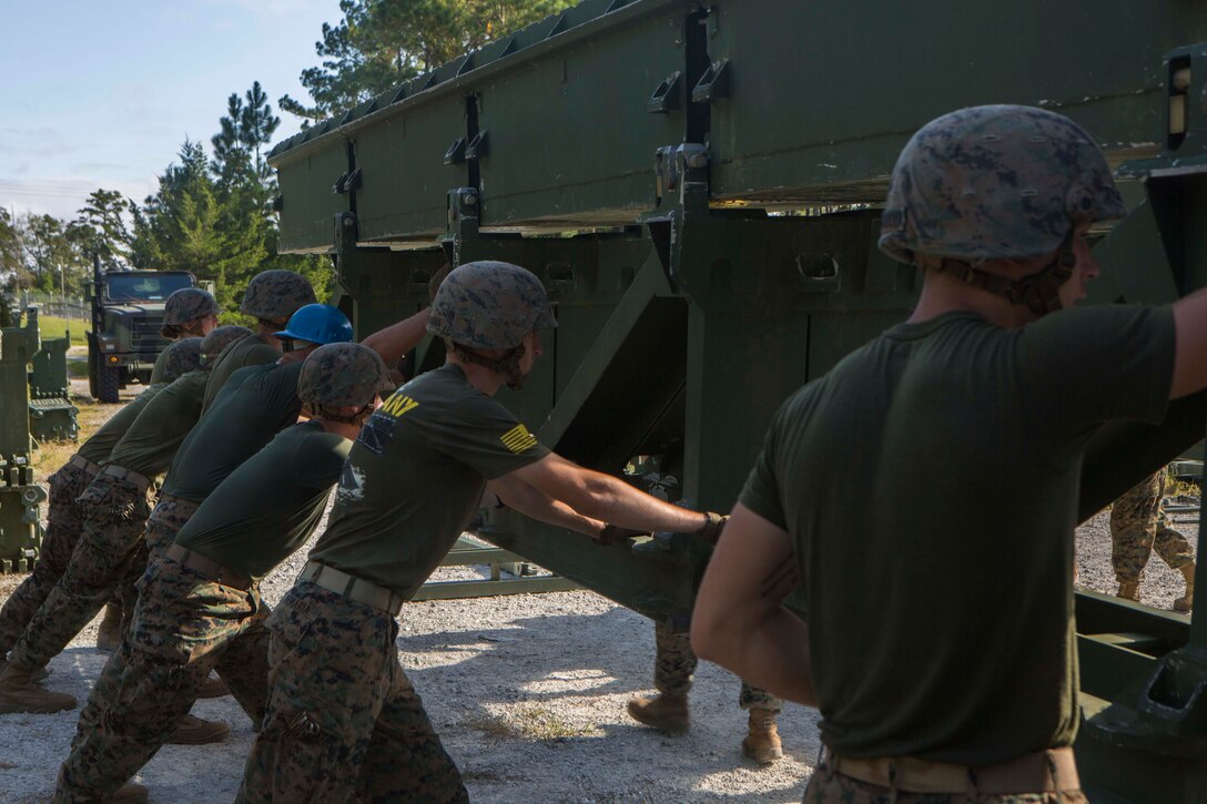 Marines with Bridge Company, 8th Engineer Support Battalion, assemble a 16-bay, double story medium girder bridge during a bridge commanders course at Camp Lejeune, N.C., Sept. 27, 2017. The course was designed to improve the ability of the bridge commander to coordinate the construction of a bridge in a timely manner. (U.S. Marine Corps photo by Lance Cpl. Abrey D. Liggins)