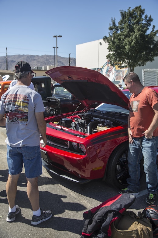 A local member of the community displays his car during the first car show at Lucky Park, Twentynine Palms, Calif., September 23, 2017. Marines from motor transportation, military police and explosive ordnance disposal came out to help the continuing effort to foster a positive relationship with the community by showing what resources the military has to offer. (Marine Corps photo by Pfc. Margaret Gale)