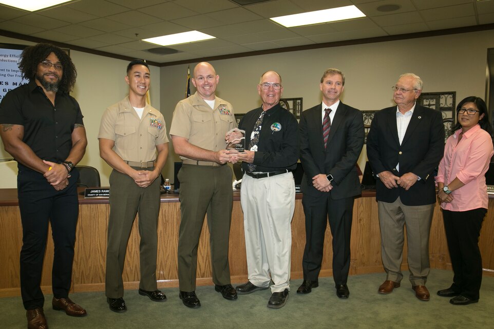 Col. Jay Wylie, assistant chief of staff, G-4 Installation and Logistics, and Maj. David Tran, environmental engineering management officer, G-4 Installation and Logistics, accept the Exemplar Award on behalf of the Marine Corps Air Ground Combat Center at the Mojave Desert Air Quality Management District headquarters, September 25, 2017. MDAQMD awarded the Combat Center for its dedication to utilizing clean energy and reducing emissions of greenhouse gasses.(U.S. Marine Corps photo by Lance Cpl. Isaac Cantrell)