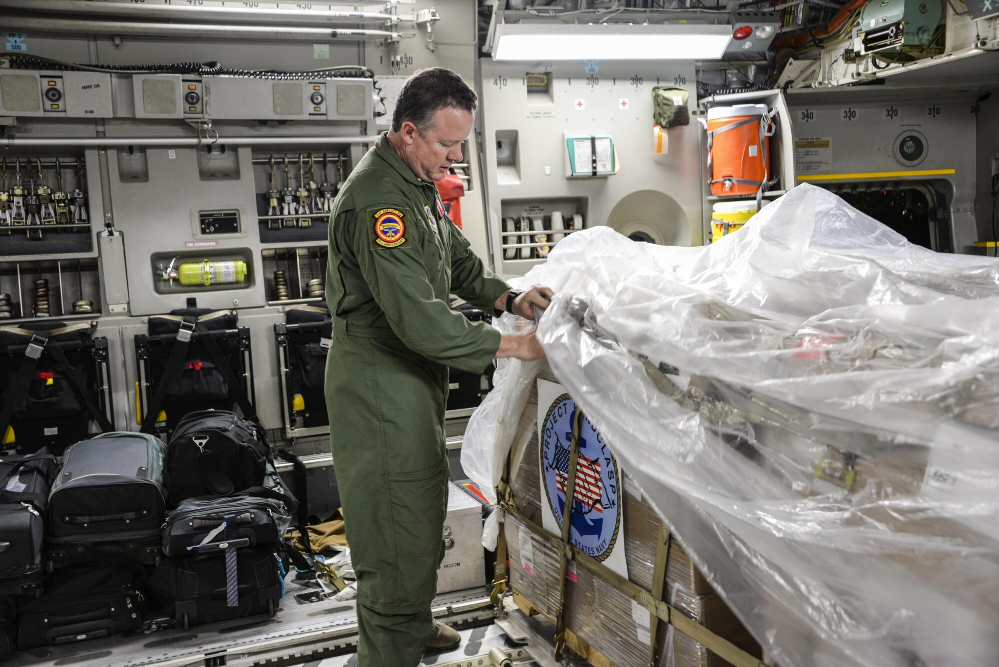 Senior Master Sgt. Toby Thompson, 21st Airlift Squadron loadmaster, secures cargo pallets on a C-17 Globemaster III Sept. 22 at North Island Naval Air Station, San Diego, Calif. At the request of Mexican civil authorities, the C-17 and its six-member crew from Travis Air Force Base, Calif., assisted U.S. efforts to provide humanitarian aid to Mexico by airlifting over 31,000 pounds of hygiene and medical supplies to the area after a 7.1-magnitude earthquake struck Mexico City Sept. 19. (U.S. Air Force photo / 2nd Lt. Sarah Johnson)