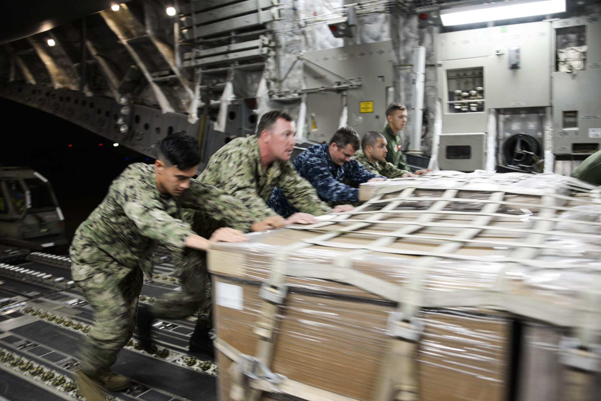 U.S. Navy supply personnel push pallets of cargo onto a U.S. Air Force C-17 Globemaster III Sept. 22 at North Island Naval Air Station, San Diego, Calif. At the request of Mexican civil authorities, the C-17 and its six-member crew from Travis Air Force Base, Calif., assisted U.S. efforts to provide humanitarian aid to Mexico by airlifting over 31,000 pounds of hygiene and medical supplies to the area after a 7.1-magnitude earthquake struck Mexico City Sept. 19. (U.S. Air Force photo / 2nd Lt. Sarah Johnson)