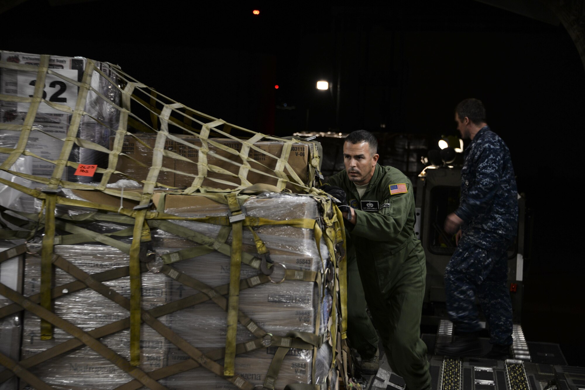 Staff Sgt. Jeremy Carrillo, 860th Aircraft Maintenance Squadron flying crew chief, pushes pallets of cargo onto a C-17 Globemaster III Sept. 22 at North Island Naval Air Station, San Diego, Calif. At the request of Mexican government, the C-17 and its six-member crew from Travis Air Force Base, Calif., assisted U.S. efforts to provide humanitarian aid to Mexico by airlifting over 31,000 pounds of hygiene and medical supplies to the area after a 7.1-magnitude earthquake struck Mexico City Sept. 19. (U.S. Air Force photo / 2nd Lt. Sarah Johnson)