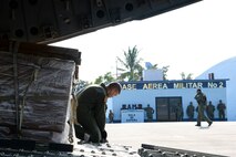 Senior Airman Dakota Maynor, 21st Airlift Squadron loadmaster, prepares to download pallets of cargo Sept. 22 at Ixetepec Airport, Oaxaca, Mexico. At the request of Mexican civil authorities, the C-17 and its six-member crew from Travis Air Force Base, Calif., assisted U.S. efforts to provide humanitarian aid to Mexico by airlifting over 31,000 pounds of hygiene and medical supplies to the area after a 7.1-magnitude earthquake struck Mexico City Sept. 19. (U.S. Air Force photo / 2nd Lt. Sarah Johnson)