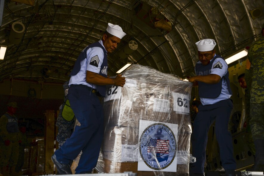 Members of the Mexican air force, navy, army and marine corps push pallets of hygiene items from a U.S. Air Force C-17 Globemaster III onto supply trucks Sept. 22 at Ixetepec Airport, Oaxaca, Mexico. At the request of Mexican civil authorities, the C-17 and its six-member crew from Travis Air Force Base, Calif., assisted U.S. efforts to provide humanitarian aid to Mexico by airlifting over 31,000 pounds of hygiene and medical supplies to the area after a 7.1-magnitude earthquake struck Mexico City Sept. 19. (U.S. Air Force photo / 2nd Lt. Sarah Johnson)